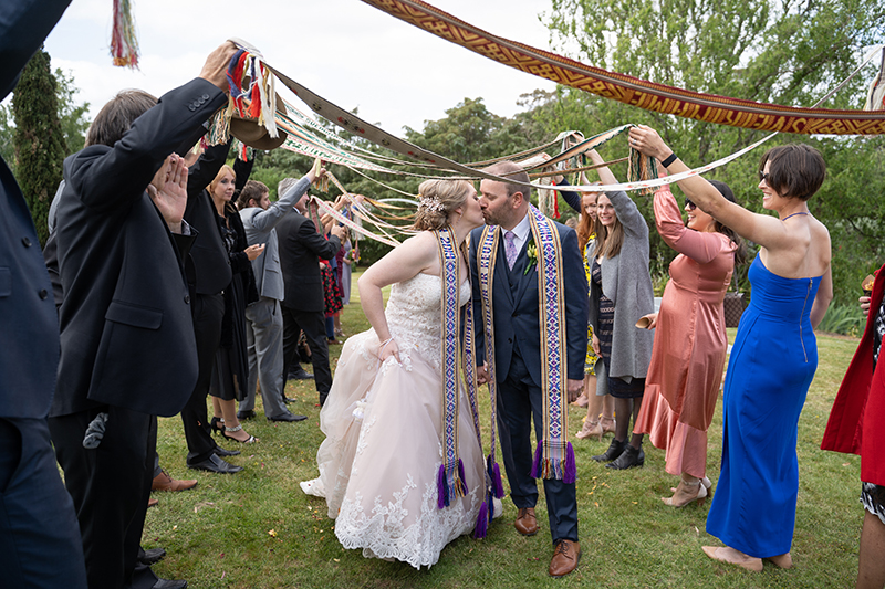 Couple walking down the aisle at Little Agapanthus Garden venue with guests holding ribbons instead of confetti., Happy couple just married wedding photography