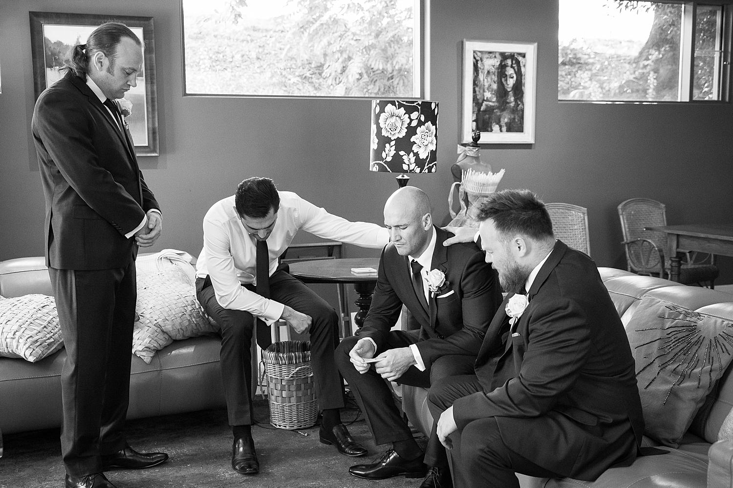 adelaide wedding photography, groom praying with groomsmen